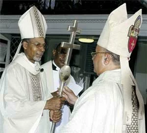 Archbishop Holder receiving the Cozier